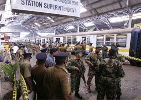 Military personnel inspect the scene of a bomb explosion at the capital railway station in Colombo