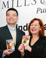 Donna Hayes (R), CEO and publisher, Mills and Boon of UK's Harlequin Enterprises, and Andrew J. Go, director of its Indian operations, display the companys books in New Delhi