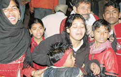 Wailing family members of the labourers buried under the debris of the under-construction Mata Mansa Devi Dwar in Panchkula