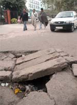 The damaged drain in front of the UGC office near Bahadur Shah Zafar Marg in the Capital on Monday. 