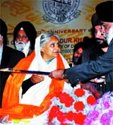 Chief Minister Sheila Dikshit being felicitated by Arvinder Singh Lovely, education minister of Delhi during the national symposium on "Guru, Granth and Panth" at Guru Tegh Bahadur Khalsa College, Delhi University on Monday.