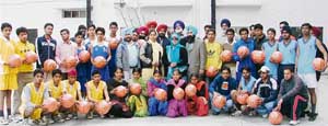 Players, who received basket balls are seen with the members of the Ludhiana District Basketball Association prior to the inauguration of the District Basketball Championship at Guru Nanak Stadium in Ludhiana on Monday. 