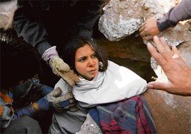 Rescue officials from the Ahmedabad Fire and Emergency Services rescue injured Sunita Lakhani who was stuck for more than 28 hours in the debris of Hotel Shakunt, in Ahmedabad, on Monday.