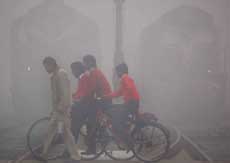 Students crossing the railway line in the wee hours on Tuesday in Bathinda. 