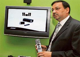 Ratish Pandey, general manager, Bose Corporation, displays Bose new lifestyle C-class home theatre systems during its launch in New Delhi