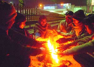 A bunch of labourers fight chilly winter night in Jalandhar on Tuesday.