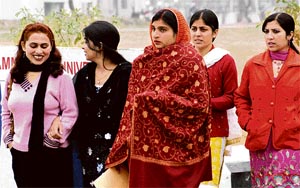 Girl students of Jammu University wear warm clothes to protect themselves from intense cold on Tuesday.