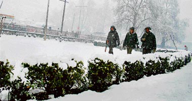 CRPF jawans patrol in Srinagar which experienced first major snowfall of the season on Tuesday.
