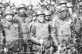 Pakistani riot policemen stand behind barbed wire near sacked Chief Justice Iftikhar Muhammad Chaudhary's residence, where supporters of Pakistan's fundamentalist party Jammat-e-Islami (JI) held a rally in Islamabad on Tuesday. 
