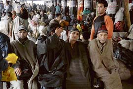 WEATHER WOES: Stranded passengers at the bus stand wait for the Jammu-Srinagar National Highway to open in Jammu on Wednesday.