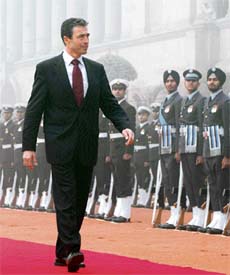 Prime Minister of Denmark Andres Fogh Rasmussen inspects a guard of honour during a welcoming ceremony on a foggy morning at Rashtapati Bhawan in New Delhi