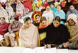 Dalit women sign the representation demanding 