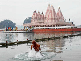 A pilgrim takes a holy dip on the occasion of Moni Amavasya at Brahmsarovar in Kurukshetra on Thursday.