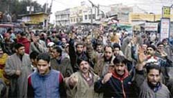 Hundreds of Srinagar-bound stranded passengers hold a protest demonstration in Jammu on Thursday.