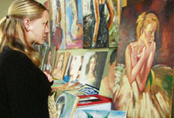 A girl looks at a painting during an exhibition organised at the Khalsa College for Women in Ludhiana