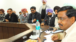 Punjab State Transport Commissioner R. Venkatesh Ratnam (right) at a meeting with the private truck and bus operaters in Bathinda