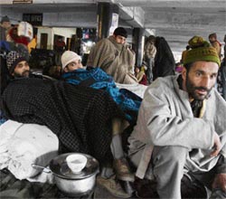 Worried Srinagar-bound passengers wait at Jammu bus stand on Friday.