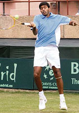 Rohan Bopanna hits a return to Uzbekistans Farrukh Dustov on the first day of the Asia-Oceania Group I Davis Cup tie at the R.K. Khanna Stadium in New Delhi on Friday.