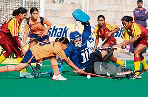 Haryana goalkeeper Savita Punia tries to thwart an attack by Jharkhand during the semifinal of the 55th Rakshak Senior Womens National Hockey Championship in Jalandhar on Friday.
