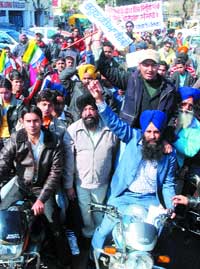 Members of the LBP take out scooter rally in Jalandhar on Saturday. 