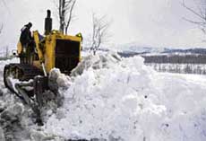 A snow-cutter clearing snow along the 300 km Jammu-Srinagar highway after heavy snowfall in Anantnag, north of Srinagar, on Saturday. 