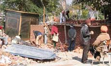 Pucca cabins coming up as the booth of a physically challenged Lalji is pushed aside in the new courts complex in Ludhiana on Saturday.