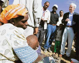 United Nations Under-Secretary-General for Humanitarian Affairs and Emergency Relief Coordinator John Holmes (right) talks to people displaced during post-election violence in Nakuru, west of Nairobi, on Saturday.