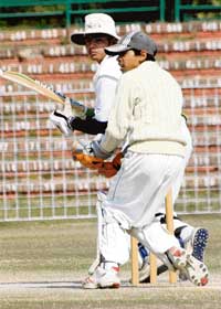 Jaskaranvir of GNPS watches his sweep shot against DAV-8 during the Adviser Cup at the Sector-16 stadium in Chandigarh on Sunday.