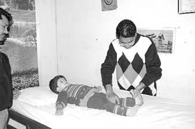 Fatehabad-based physiotherapist Dr Davinder Singh lends his healing touch to a physically challenged child