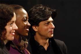 Shah Rukh Khan poses with actresses Maria Schrader from Germany (left) and Nigerian Kate Henshaw-Nuttall prior to a discussion themed "Love International" on the sidelines of the 58th International Berlinale Film Festival