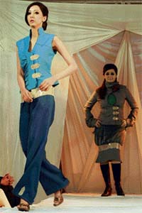 Models present creations by Pakistani fashion designers during a fashion show at a university in Islamabad