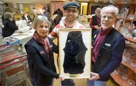 Kristina Warming (left) and Bernt Dehlgren (right) of the charitable group Bistandscenter in Eslov, Sweden, post with Zlatko Nedowanski who donated the swimsuit Nicole Kidman left at a Swedish pool in 2002