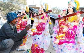 An artist gives final touches to goddess Saraswatis idol for Basant Panchami celebrations in Bathinda on Monday.