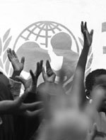 Children belonging to the Kikuyu tribe raise their hands while following an activity in a camp for displaced people  in Kenya. More than 1,000 people have been killed and 300,000 displaced in tribal violence.  AFP