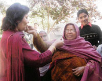Sanjay Dutts aunt Puneeta Dutt (left) distributes sweets to celebrate his marriage in Mandoli village in Yamunanagar district on Monday.