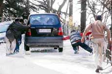 A slippery, arduous climb for this Santro car in Shimla on Monday.
