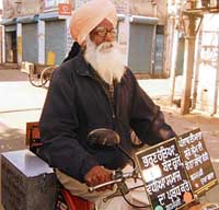 Harbans Singh Brahmpuri with slogans against female foeticide on his vehicle. 