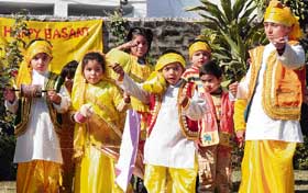 Children welcome the arrival of spring by flying kites at Kiddies Paradise School in Ludhiana on Monday. 