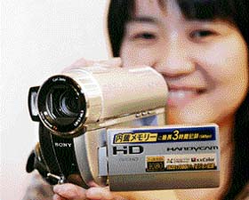 A Sony employee displays the company's hybrid comcorder "Handycam HDR-UX20", equipped with a 4 mega-pixel CMOS image sensor