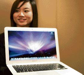 Apple Computers product marketing manager (Asia Pacific) Angeline Tan displays the world's thinnest notebook "MacBook Air" in Mumbai