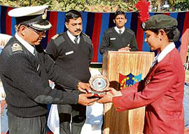 Commander D.V. Singh, Commanding Officer, No.1 Chandigarh Naval Wing, presents an award to a cadet at a function held in Chandigarh on Tuesday.