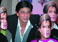 Shah Rukh Khan poses along with children wearing masks during the promotion of television show, Kya Aap Panchvi Pass Se Tez Hain?, in the Capital on Tuesday.