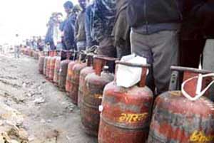 A large number of people queue up to get their gas cylinders refilled in Jammu on Tuesday. 