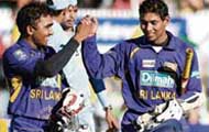 Sri Lankan batsmen Mahela Jayawardene (L) and Tillakaratne Dilshan (R) celebrate after their team's win over India at Manuka Oval in Canberra on Tuesday.