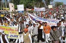 Farmers stage a demonstration in Hisar on Wednesday, seeking compensation for damage to crops due to cold weather. 