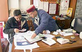 Food and supply inspectors check the record of an LPG agency at New Shimla on Wednesday.