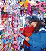 Girls select Valentines Day cards at a gift shop in Shimla on Wednesday.