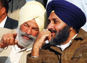 SAD general secretary Balwinder Singh Bhunder sharing a point with SAD chief Sukhbir Singh Badal at Kahnewal village in Mansa district, on Thursday. 