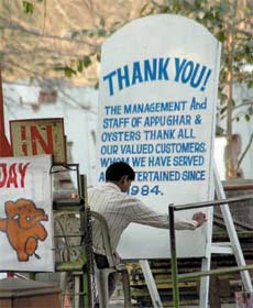 As curtains draw on the famous amusement park Appu Ghar, a man is busy painting a board thanking the valued customers in the Capital
