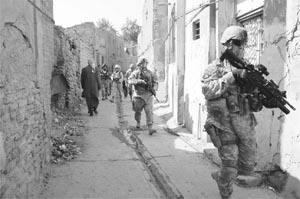 An American military training team and their Iraqi army colleagues conduct a foot patrol in the city of Samarra in northern Iraq.